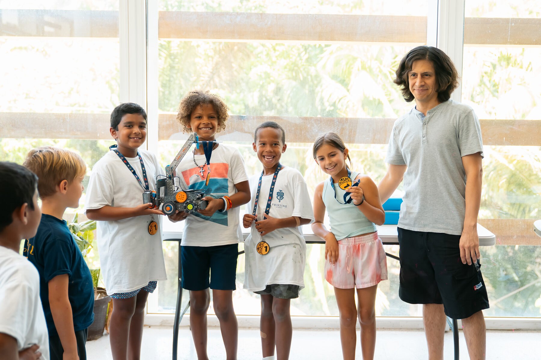 Young builders showing the robot they built